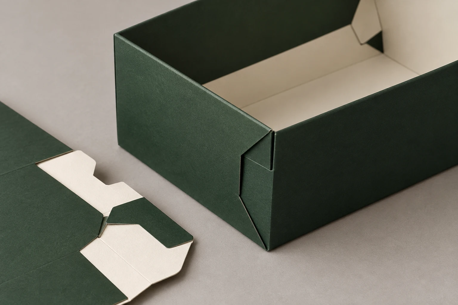MUGE design-direction concept close-up of a deep green foldable gift box paperboard corner lock