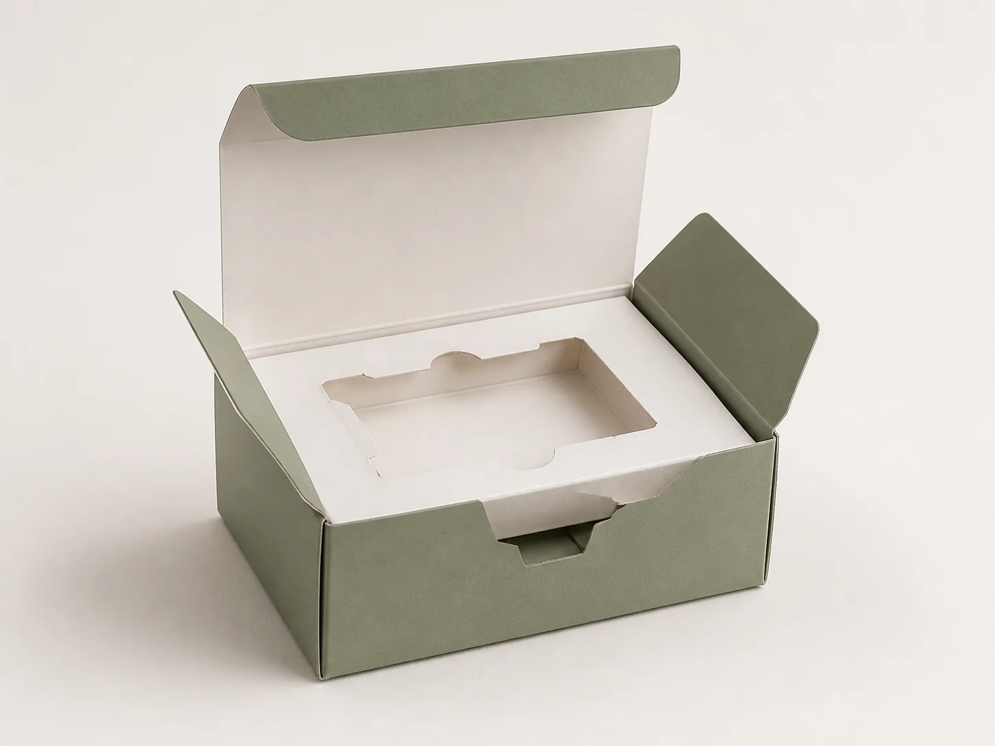 MUGE design-direction concept of an open sage-green paperboard folding carton with a white folded-paperboard insert